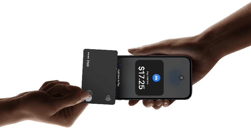 Two hands making a contactless payment. One hand holds a card reader, the other a smartphone displaying a $17.25 payment confirmation.